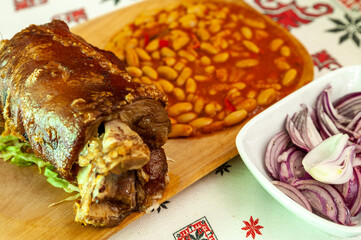 delicious bean with smoked pork knuckle served with sliced red onion
