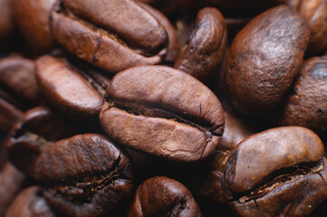 Naklejka premium Coffee beans close up for background in shallow depth of field. macro photography