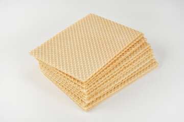 Close up of stack of wafer or waffle sheets on a white background. Shallow depth of field
