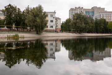 Fototapeta premium Ufa, Russia,st. Lenina, Park of Culture and Leisure Modern buildings near the large lake. Green trees around