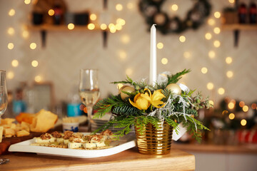 Obraz na płótnie Canvas Cozy evening for valentine's day or Christmas celebration concept. Candlelight dinner table setup for couple with beautiful light as background. Enjoying a romantic candlelight dinner together.