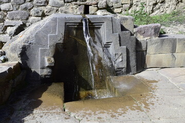 Ancient water source in Inca ruins of Ollantaytambo, Peru. Ancient building in Sacred Valley in Peruvian Andes