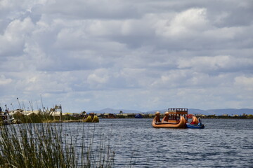 Traditional boats in the floating and tourist Islands of lake Titicaca Puno Peru South America