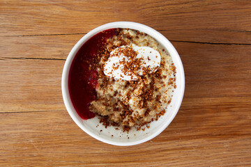Oatmeal with yogurt berry mousse and granola in bowl
