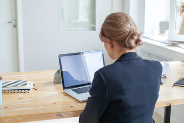 Empty laptop display and business woman working in an office and using laptop