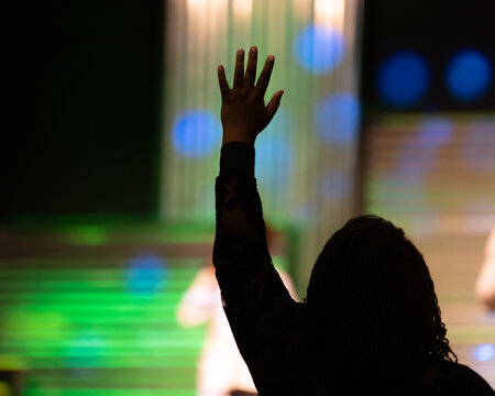 Silhouette of a Persons Hand Raised at Church