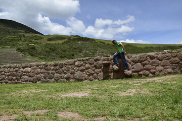 A person on the territory Inca terraces of Moray. Moray is an archaeological site near the Sacred Valley