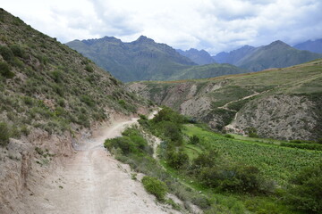 Fototapeta na wymiar The road between the mountains to the salt terraces of Maras in the Andes mountain range in the region of Cusco, Peru