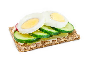 Whole Grain Crispbread with Fresh Cucumber, Egg, Cream Cheese and Radish - Isolated on White. Quick...