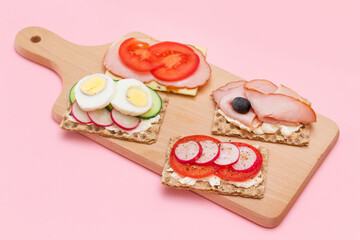 Different Whole Grain Crispbread with Ham, Tomato, Radish, Cucumber and Cheese. Easy Breakfast. Diet Food. Quick and Healthy Sandwiches. Crispbread with Tasty Filling. Healthy Dietary Snack
