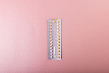 Directly above shot of medicine blister pack isolated against pink background, copy space
