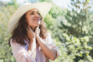 Young adult brown hair woman wearing sun hat enjoying summer.