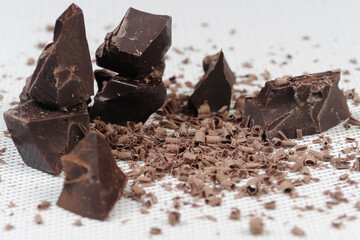 Broken dark chocolate and cocoa powder on a table