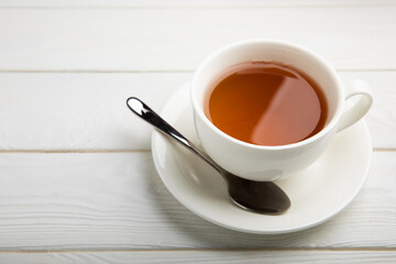 Cup of green organic tea on white texture wood.Tea ceremony. View from above. Copy space