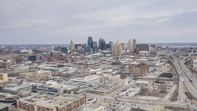 Time lapse drone video of Kansas City skyline with busy highway during daytime with clear weather