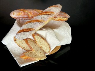 French baguette isolated on black background, traditional fresh bread for  meal  