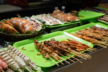 Grilled calamari and seafood Chinese snacks on the street.