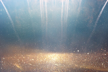background of abstract gold, black and blue glitter lights with fireworks. defocused