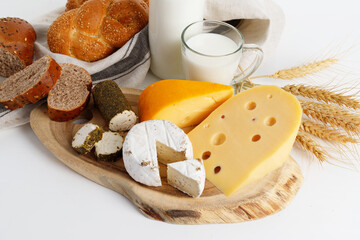 Different kinds of cheese and bread  on wooden board. The concept of the Israeli holiday Shavuot