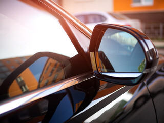Anti-glare rearview mirror on a black car.