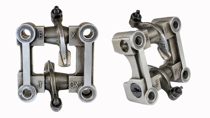 Components of an internal combustion engine, motorcycle, cultivator, lawn mower are photographed in two planes in one photo. Camshaft housing with rocker arm on a white background