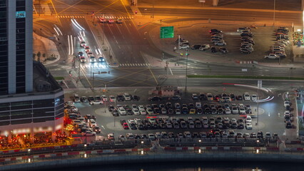 Aerial view of a parking lot with many cars in rows night timelapse