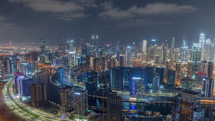 Fototapeta na wymiar Skyline with modern architecture of Dubai business bay towers night timelapse. Aerial view