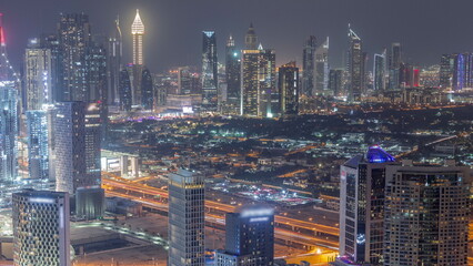 Rows of skyscrapers in financial district and business bay in Dubai aerial night timelapse.