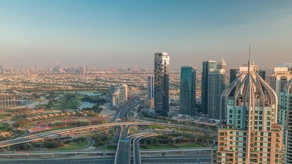 Fototapeta na wymiar Huge highway crossroad junction between JLT district and Dubai Marina intersected by Sheikh Zayed Road aerial timelapse.
