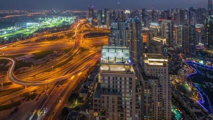 Fototapeta na wymiar Dubai marina and JLT skyscrapers along Sheikh Zayed Road aerial day to night timelapse.