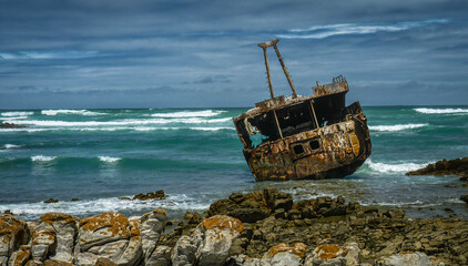 Ship wreck during stormy sea near Cape Agulhas in Republic of South Africa.