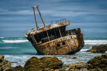 Ship wreck during stormy sea near Cape Agulhas in Republic of South Africa.
