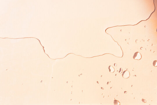 Top view of spilled water on the table with sunlit water drops. Remnant of water drops with varied sizes and shapes. Copy space.