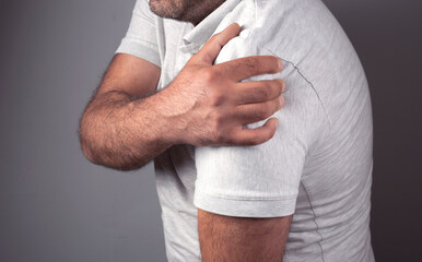 A middle-aged man has shoulder pain.