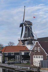 Fototapeta na wymiar Molen de Adriaan is a smocked windmill that sits on the scenic Spaarne River in central Haarlem. Molen de Adriaan originally built in 1779. Haarlem, North Holland, the Netherlands.