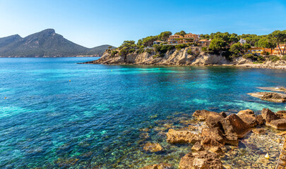 Mallorca island, beach in Sant Elm. Seashore, azure sea and buildings