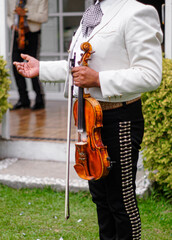 Traditional Mexican mariachi playing the violin in a typical party
