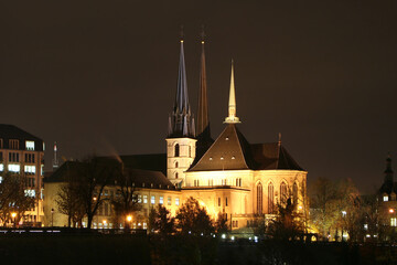 Fototapeta na wymiar The gothic Notre-Dame Cathedral (1613) in bright lighting in the capital downtown at night. Luxembourg