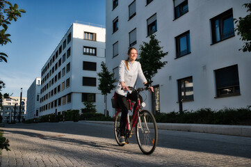 A woman rides a bicycle through the city of Munich