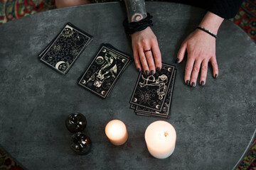From above view shot of mysterious mature woman interested in esotericism setting and reading tarot...