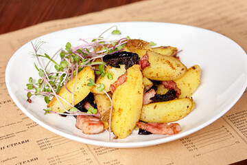 baked potatoes with microgreens, bacon and prunes