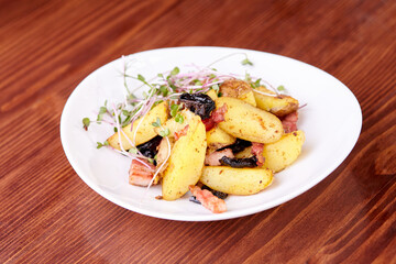 baked potato dish with microgreens on a white plate