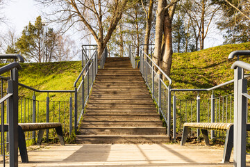 Wooden platform with steel handrails in the city park