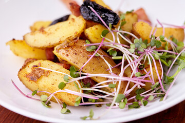 Fototapeta na wymiar baked potato dish with microgreens on a white plate