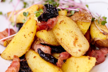 baked potatoes, baked potato dish with microgreens on a white plate close up