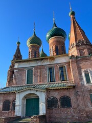 Fototapeta na wymiar Red brick old orthodox church, blue sky background