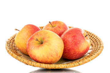 Four juicy organic apples with a ceramic dish, close-up, isolated on a white background.