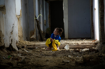 Children against war. A child plays in a bomb shelter. Ukrainian children during the war. Destroyed Ukrainian houses. Consequences of the war in Ukraine. War in Ukraine.