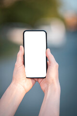 Hands holding amsrtphone with blank screen without notch