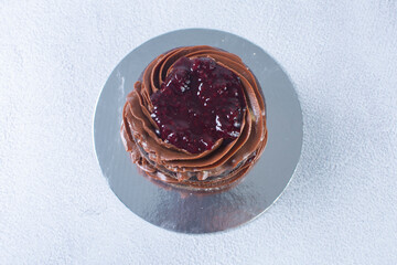 Chocolate cake and blackberry sauce on a gray background